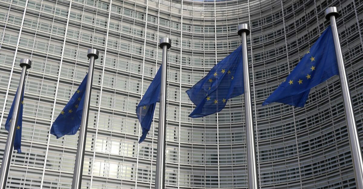 Five flags in front of European Commission building